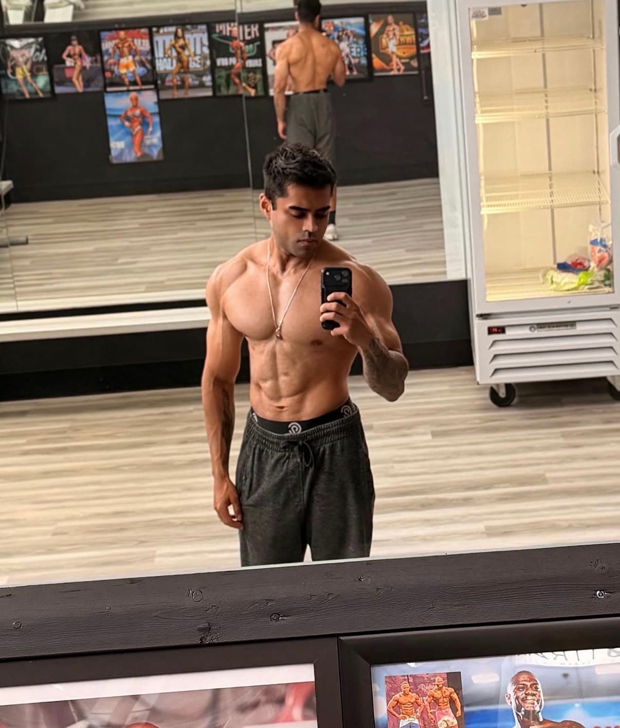 Abe Seth in a gym mirror photo showing a lean athletic physique.