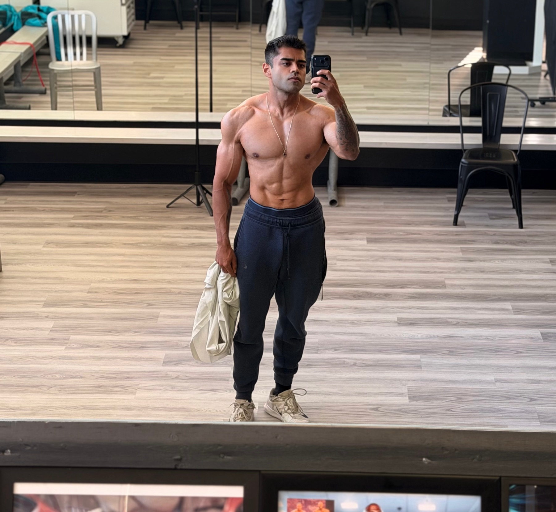 Abe Seth in a full-body mirror check-in wearing joggers.